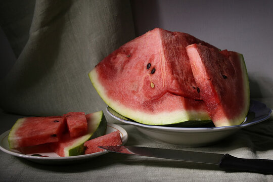 A juicy, sweet, ripe watermelon lies on a plate.