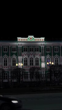 Vertical video. S-Log. Yekaterinburg, Russia. House of Sevastyanov and The central street of the city is Lenin Prospect. Night city in the early spring. Rich colors