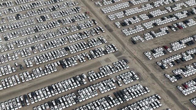 Aerial view of a vast parking lot filled with rows of new cars in Chennai, Tamil Nadu, India.