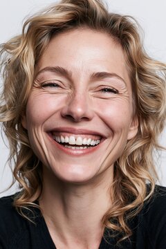 Happy woman experiencing joy and laughing intensely