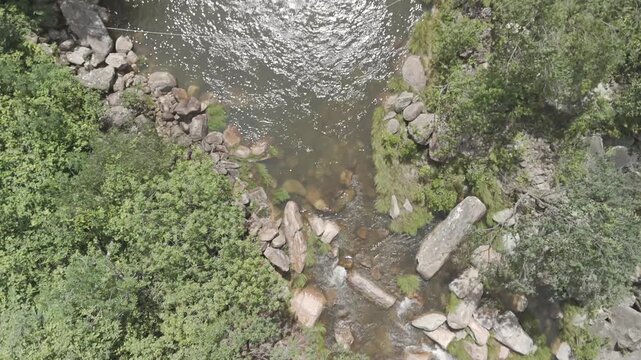 Aerial view of the river flowing through the rocky landscape of Chapada dos Veadeiros in Alto Paraiso de Goias, Goias, Brazil.
