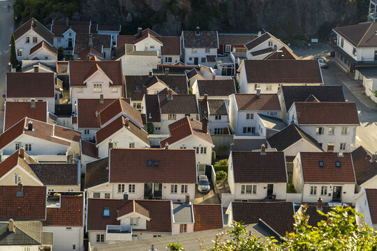 View of the historic town of Mandal with its characteristic white wooden houses and red tiled roofs in Mandal, Agder, Norway.