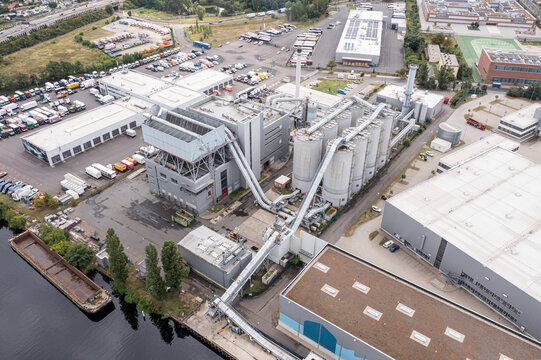 Aerial view of the BTB HHKW Neukolln power plant with its large silos, conveyor systems, and surrounding industrial infrastructure in Berlin, Berlin, Germany.