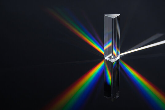 Optical Prism Casting Rainbow Light Spectrum on Dark Background
