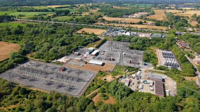 Aerial view of the National Grid Nursling Substation featuring electrical transformers and power infrastructure surrounded by lush greenery in Nursling, England, United Kingdom.