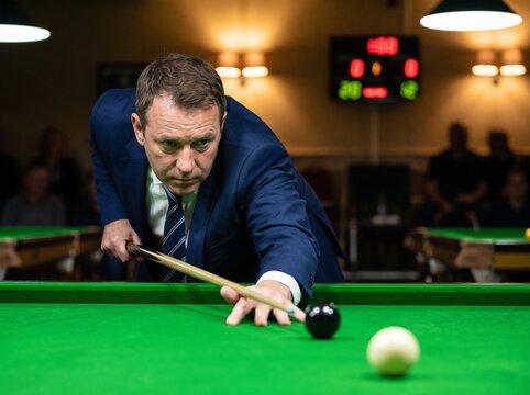  Focused Middle Aged Snooker Player in Navy Blue Suit Aiming Cue at Black Ball on Green Felt Table in Dimly Lit Tournament Hall Professional Sports Concept
