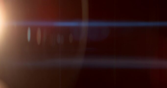 Cinematic moving lens flare overlay in super slow motion featuring glow, soft optical reflections and realistic lens artifacts on a black background. Premium VFX element for compositing.