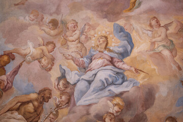 Naklejka premium A beautiful painting of the Virgin Mary with little angels on the ceiling of a chapel.