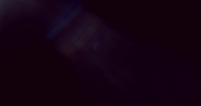 Cinematic moving lens flare overlay in super slow motion featuring glow, soft optical reflections and realistic lens artifacts on a black background. Premium VFX element for compositing.