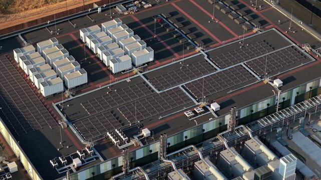 Aerial view of a hyperscale data center featuring rows of cooling units and technical infrastructure on the roof in Didcot, England, United Kingdom.