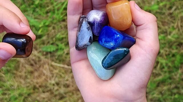Natural minerals in hand. Semi-precious multi-colored stones, minerals close-up. Mineralogy. Collection of minerals.	