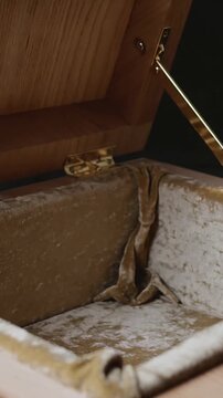 Vertical video: Sequence starting carved box lid lifting on table, showing brass hinge and velvet