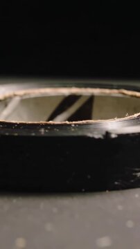 Vertical video: Panning camera revealing disc in studio, exposing scuffed rim and frayed ring