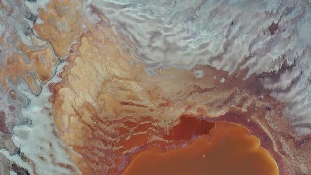 Aerial view of colorful salt evaporation ponds with orange and white mineral deposits at the Dead Sea, Beersheba, South District, Israel.