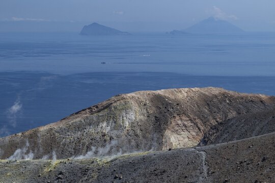 Crater rim, sulfur vapors rising, in the background Panarea and Stromboli volcano, Vulcano, Aeolian or Lipari islands, Sicily, southern Italy, Italy