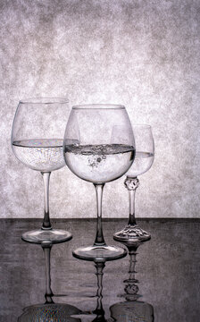 Still life with glasses of liquid on a gray background