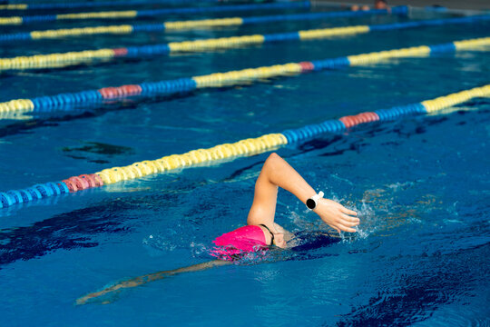 Female swimmer training for discipline and self-improvement in a professional pool