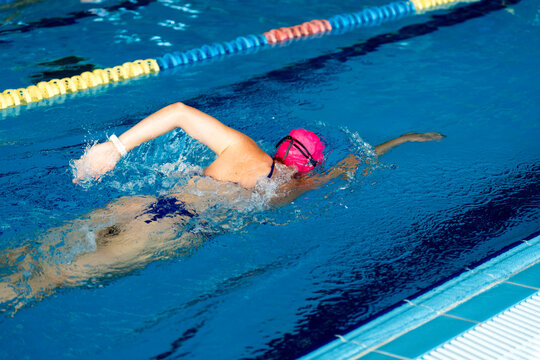 Female swimmer training in pool, embodying sport, discipline, and self-improvement