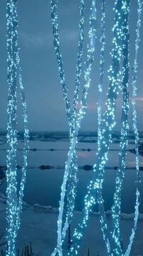 Vertical video: Looping cyan strands swaying on tidal flat at dusk, showing spikes and pools