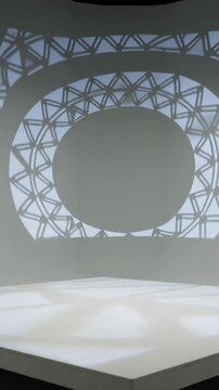 Vertical video: Light revealing geometric pattern across gallery corner animating white pedestal