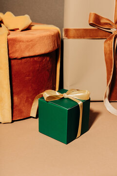 Elegant Holiday gift boxes with gold ribbon and bow