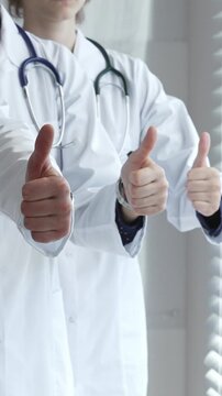 Doctor team showing thumbs up, symbolizing healthcare success, medical approval, achieving goals, quality patient care, positive health outcomes, and professional support