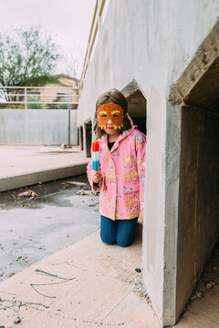 Fall Portrait of a girl in raincoat and mask