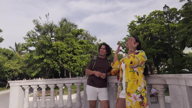 Surprised tourist couple talking in a beautiful park