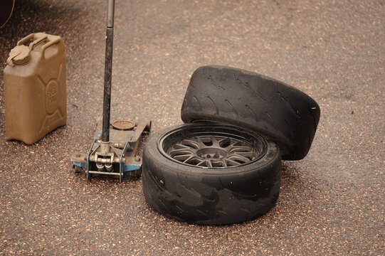 Racing car tire change equipment on asphalt track