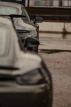 Sports cars lined up on a wet racing track