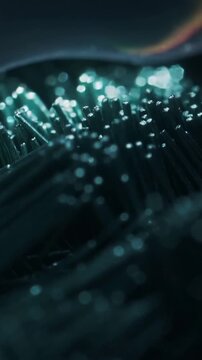 Vertical video: Gliding thin iridescent film across fiber bed, cool light shifting, revealing tips