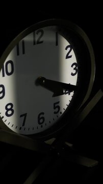 Clock hand moving timelapse. Window blind shadow moving across clock face. Time passing concept.