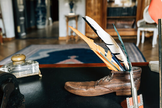 Vintage quill pen holder in antique leather shoe