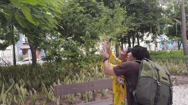 Young tourist couple taking selfie in a city park