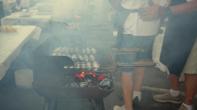 Grill master cooking street food on a smoky barbecue amidst flying embers, creating a delicious aroma