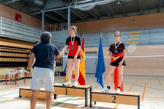 Junior badminton tournament medal ceremony on podium