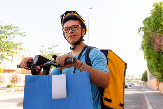Scooter courier carrying delivery package on urban street