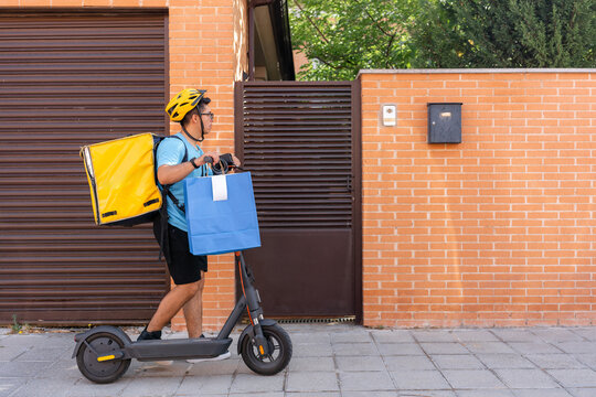 Delivery courier on electric scooter carrying food order