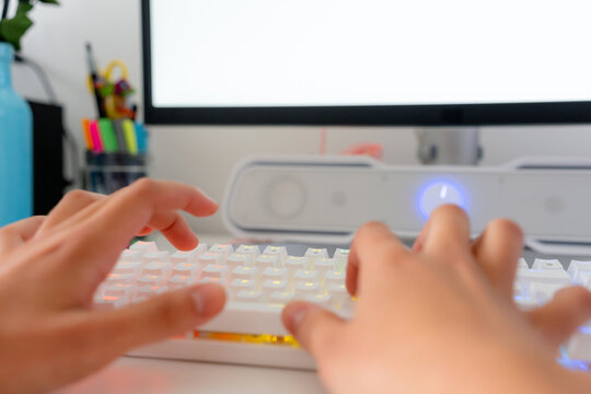 Young woman play computer game on desktop keyboard