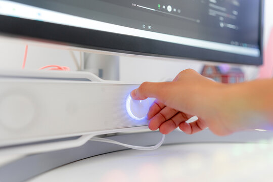 Young woman adjust desktop computer speaker for gaming