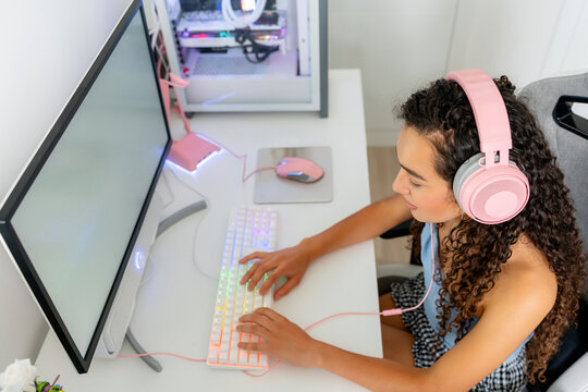Young woman play computer game at desktop setup