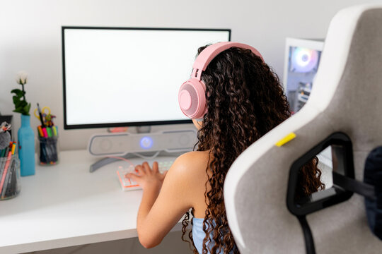 Young woman play computer game at desktop setup