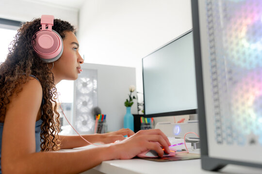 Young woman play computer game at desktop workstation