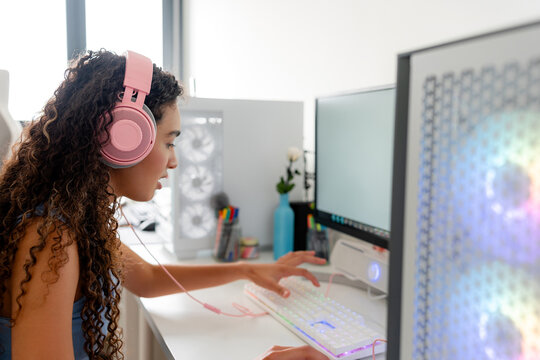 Young woman play computer game at desktop setup