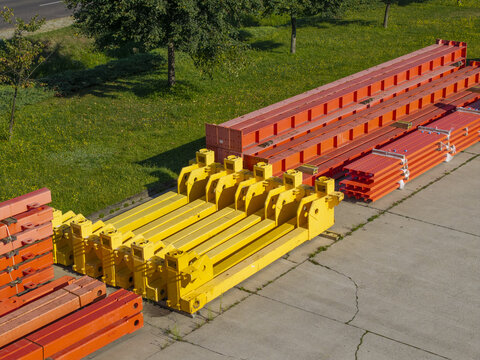 Aerial view of PERI Polska industrial equipment including yellow and orange steel construction components stored on a concrete yard in Jaworzno, Wojewodztwo slaskie, Poland.