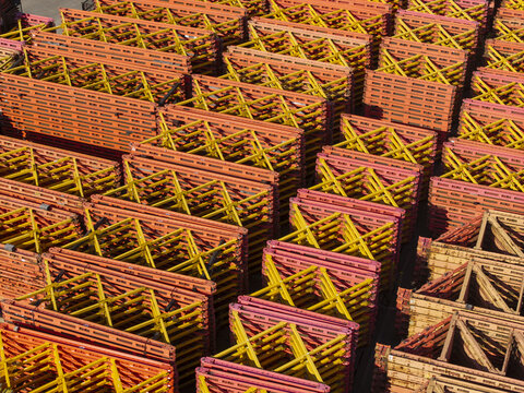Aerial view of stacked yellow and orange metal construction formwork frames at the PERI Polska facility in Jaworzno, Wojewodztwo slaskie, Poland.