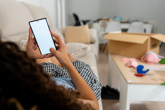 Young woman check second-hand marketplace app on smartphone