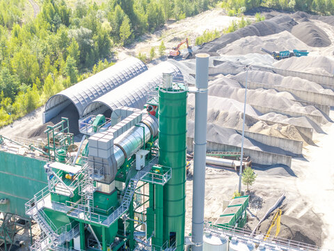 Aerial view of Masfalt Sp. z o.o. WMB asphalt plant featuring green industrial machinery, storage silos, and piles of gravel in Dabrowa Gornicza, Wojewodztwo slaskie, Poland.