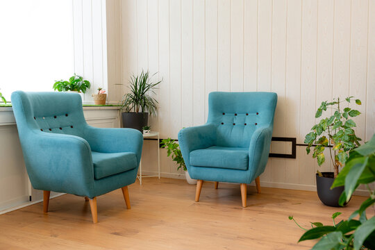 Turquoise armchairs in a calming osteopathy clinic interior