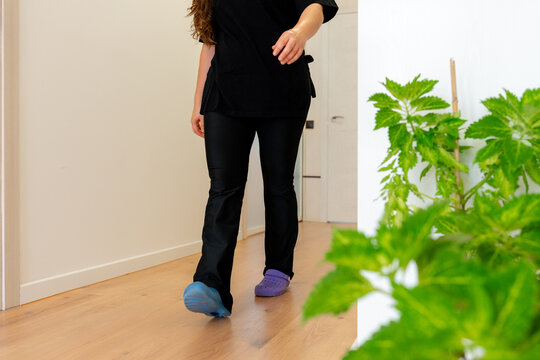 Osteopathy therapist walking through clinic treatment room